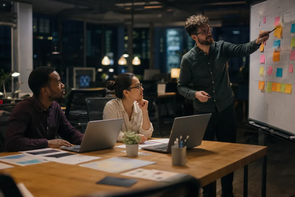Creator agency team planning chat shifts in an office at night