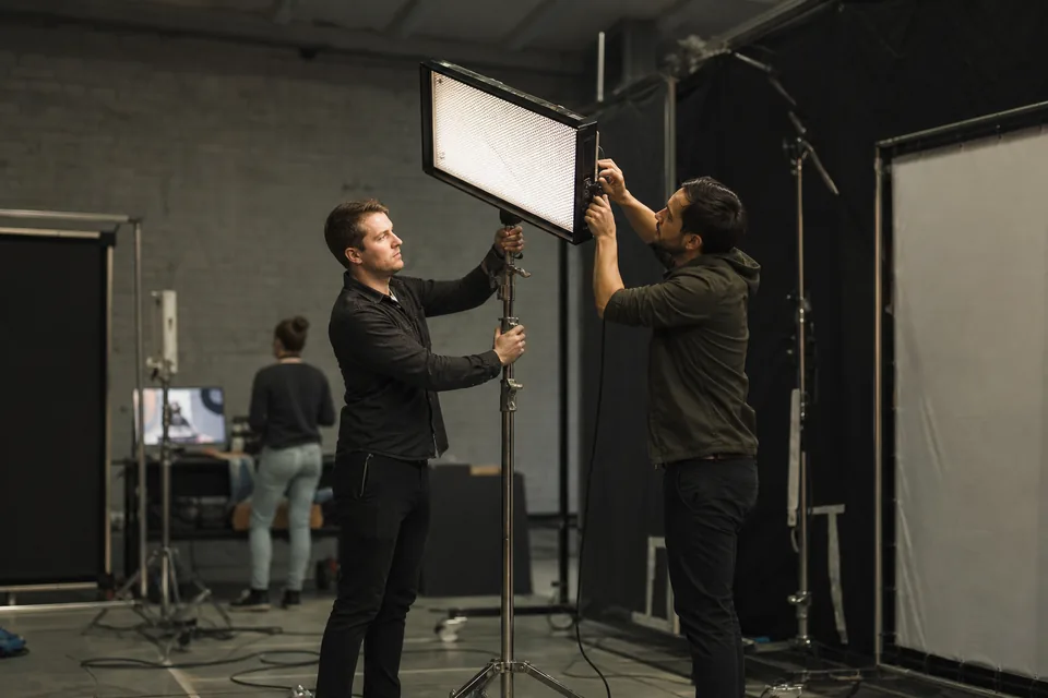 Studio crew setting lights on a set